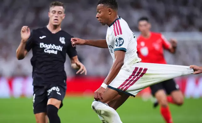 Real Sociedad's Jon Aramburu pulls back Real Madrid's Kylian Mbappe during the La Liga soccer match between Real Madrid and Real Sociedad in Madrid, Spain, Wednesday, Aug. 26, 2026. (AP Photo/Manu Fernandez)