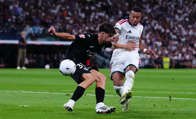 Real Madrid's Kylian Mbappe scores by[ Real Sociedad's Jon Martin during the La Liga soccer match between Real Madrid and Real Sociedad in Madrid, Spain, Wednesday, Aug. 26, 2026. (AP Photo/Manu Fernandez)