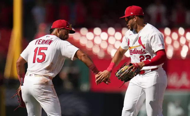 St. Louis Cardinals' Joshua Báez (22) and José Fermín (15) celebrate a victory over the Baltimore Orioles following a baseball game Thursday, Aug. 27, 2026, in St. Louis. (AP Photo/Jeff Roberson)