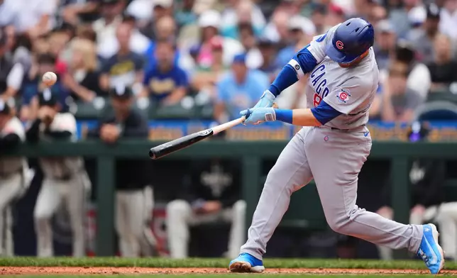 Chicago Cubs' Ian Happ hits a grand slam against the Seattle Mariners during the third inning of a baseball game, Sunday, Aug. 23, 2026, in Seattle. (AP Photo/Lindsey Wasson)