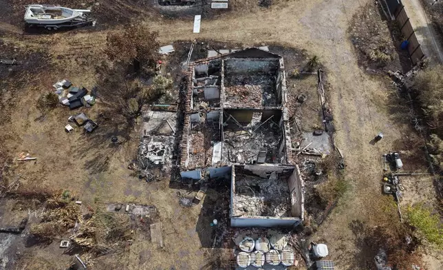 An aerial view of a homes burned by wildfires in Le Porge, southwestern France, Saturday, Aug. 1, 2026. (AP Photo/Nicolas Garriga)