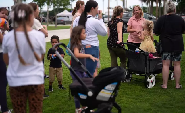 U.S. Rep. Debbie Wasserman Schultz, third from right, greets constituents at a National Night Out community event while campaigning for Florida's 20th congressional district, in Plantation, Fla., Tuesday, Aug. 4, 2026. (AP Photo/Rebecca Blackwell).