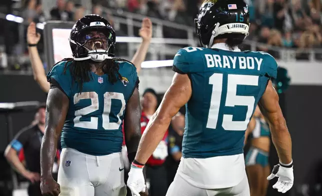 Jacksonville Jaguars running back DeeJay Dallas (20) celebrates a touchdown during the second half of an NFL preseason football game against the Tampa Bay Buccaneers, Friday, Aug. 28, 2026, in Jacksonville, Fla. (AP Photo/Phelan M. Ebenhack)