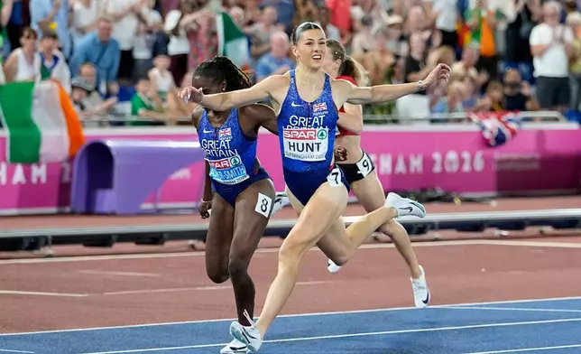 Amy Hunt of Britain crosses the finish line to win the women's 200 meters final at the European Athletics Championships in Birmingham, England, Thursday, Aug. 13, 2026. (AP Photo/Matthias Schrader)
