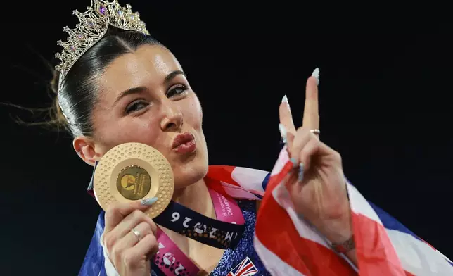 Amy Hunt of Britain poses with her gold medal after winning the women's 200 meters final at the European Athletics Championships in Birmingham, England, Thursday, Aug. 13, 2026. (AP Photo/Morgan Harlow)