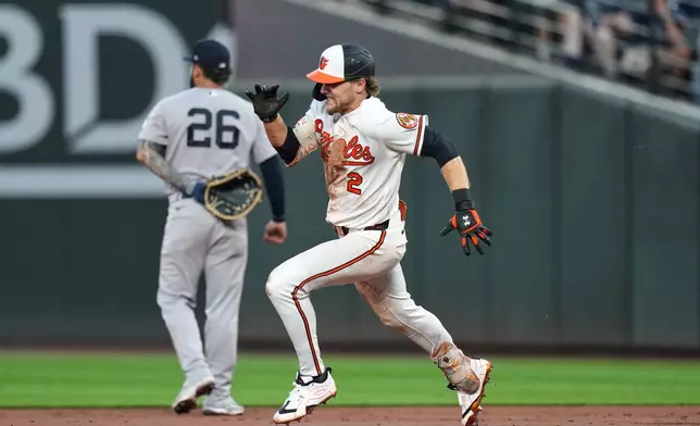 Baltimore Orioles' Gunnar Henderson (2) advances toward second base past New York Yankees first baseman Luis García Jr. (26) after hitting a double during the third inning of a baseball game, Wednesday, Aug. 19, 2026, in Baltimore. (AP Photo/Stephanie Scarbrough)