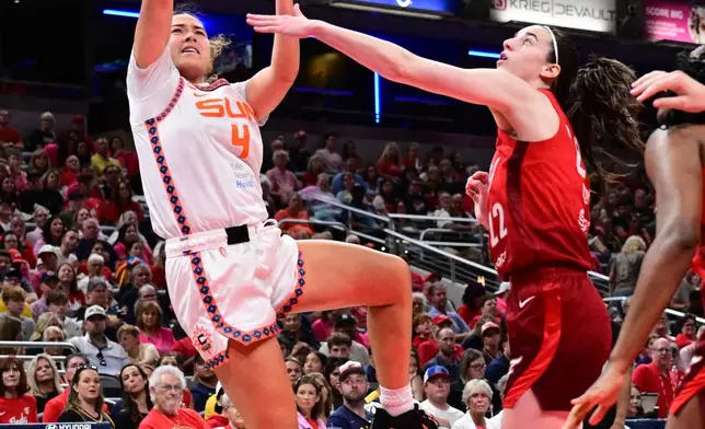 Connecticut Sun guard Charlisse Leger-Walker (4) shoots the ball over Indiana Fever guard Caitlin Clark (22) during the second half of a WNBA basketball game, Friday, Aug. 28, 2026, in Indianapolis. (AP Photo/Marc Lebryk)
