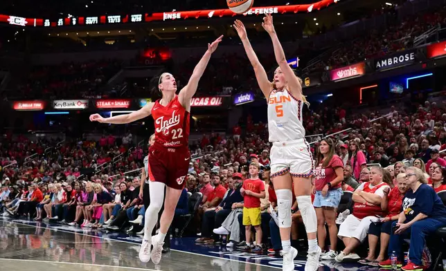 Connecticut Sun guard Shey Peddy (5) shoots the ball in front of Indiana Fever guard Caitlin Clark (22) during the second half of a WNBA basketball game, Friday, Aug. 28, 2026, in Indianapolis. (AP Photo/Marc Lebryk)