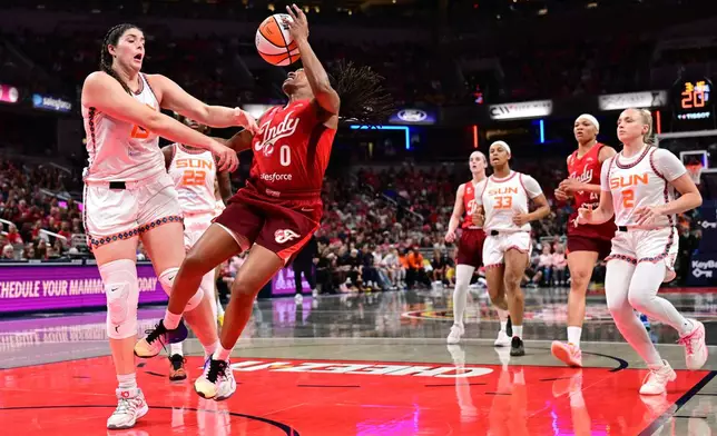 Connecticut Sun forward Raegan Beers (15) fouls Indiana Fever guard Kelsey Mitchell (0) during the first half of a WNBA basketball game, Friday, Aug. 28, 2026, in Indianapolis. (AP Photo/Marc Lebryk)