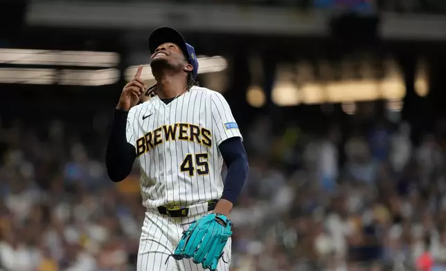 Milwaukee Brewers' Abner Uribe gestures as he walks to the dugout during the seventh inning of a baseball game against the Minnesota Twins, Saturday, Aug. 8, 2026, in Milwaukee. (AP Photo/Aaron Gash)