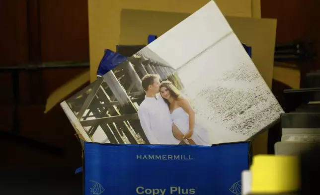 A wedding photo is seen in a bin of papers during the murder trial for Lindsay Clancy at Plymouth Superior Court in Plymouth, Mass., on Thursday, July 30, 2026. (CJ Gunther/The Boston Herald via AP, Pool)