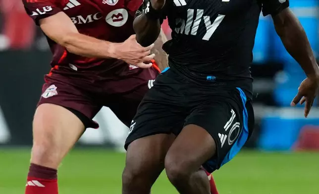 Charlotte FC's Allan Saint-Maximin (10) takes the ball past Toronto FC's Josh Sargent (9) during second half MLS soccer action in Toronto, on Wednesday, Aug. 19, 2026. (Chris Young/The Canadian Press via AP)