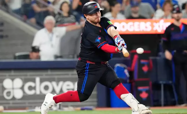 Toronto Blue Jays Alejandro Kirk (30) hits a RBI double off New York Yankees pitcher Gerrit Cole (45) during sixth inning of a baseball game in Toronto, Friday, Aug. 14, 2026. (Chris Young/The Canadian Press via AP)