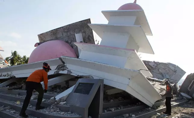 Rescuers inspect the ruins of a mosque that collapsed during an earthquake in North Lamba Leda, East Nusa Tenggara province, Indonesia, Tuesday, Aug. 18, 2026. (AP Photo/Firdia Lisnawati)