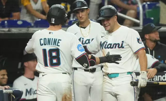 Miami Marlins left fielder Griffin Conine (18) celebrates his home run with Jakob Marsee during the fourth inning of a baseball game against the Pittsburgh Pirates Wednesday, Aug. 12, 2026, in Miami. (AP Photo/Marta Lavandier)