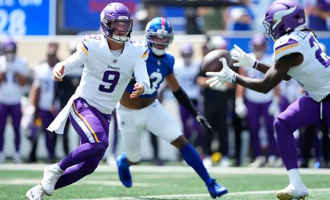 Minnesota Vikings quarterback J.J. McCarthy (9) pitches the ball to running back Demond Claiborne during the first half of a preseason NFL football game against the New York Giants Saturday, Aug. 15, 2026, in East Rutherford, N.J. (AP Photo/Yuki Iwamura)