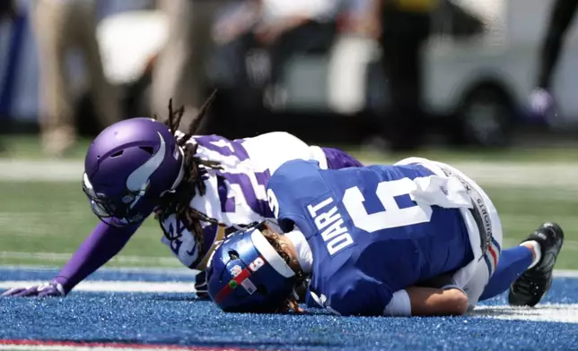 New York Giants quarterback Jaxson Dart (6) is sacked by Minnesota Vikings safety Jay Ward (24) during the first half of a preseason NFL football game Saturday, Aug. 15, 2026, in East Rutherford, N.J. (AP Photo/Adam Hunger)