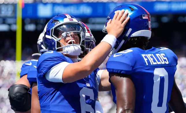 New York Giants' Jaxson Dart (6) celebrates with wide receiver Malachi Fields (0) after connecting for a touch pass against the Minnesota Vikings during the first half of a preseason NFL football game Saturday, Aug. 15, 2026, in East Rutherford, N.J. (AP Photo/Yuki Iwamura)