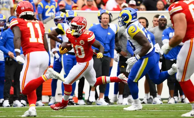 Kansas City Chiefs running back Emmett Johnson runs against the Los Angeles Rams during the first half of an NFL preseason football game, Saturday, Aug. 15, 2026, in Kansas City, MO. (AP Photo/Reed Hoffmann)