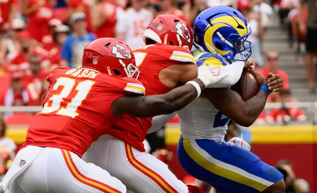Los Angeles Rams running back Kyren Williams is tackled by the Kansas City Chiefs during the first half of an NFL preseason football game, Saturday, Aug. 15, 2026, in Kansas City, MO. (AP Photo/Reed Hoffmann)