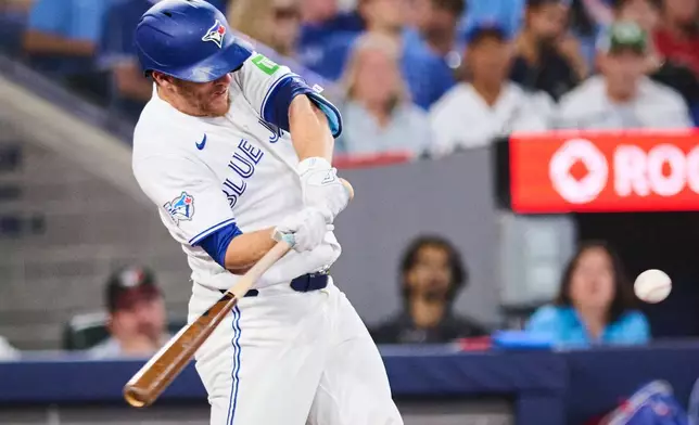Toronto Blue Jays' Myles Straw (3) hits an RBI double against the Boston Red Sox during eighth inning MLB baseball action in Toronto, on Tuesday, Aug. 11, 2026. (Sammy Kogan/The Canadian Press via AP)