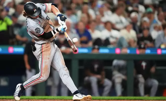 Minnesota Twins' Luke Keaschall hits an RBI double against the Seattle Mariners during the seventh inning of a baseball game, Friday, July 31, 2026, in Seattle. (AP Photo/Lindsey Wasson)