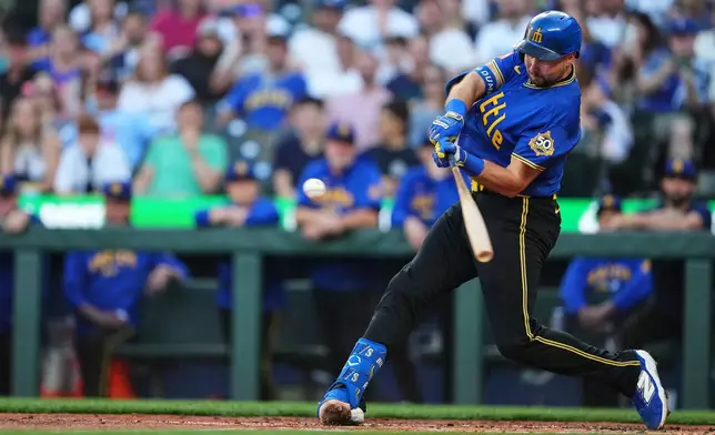 Seattle Mariners' Cal Raleigh hits a two-run ground-rule double against the Minnesota Twins during the first inning of a baseball game, Friday, July 31, 2026, in Seattle. (AP Photo/Lindsey Wasson)