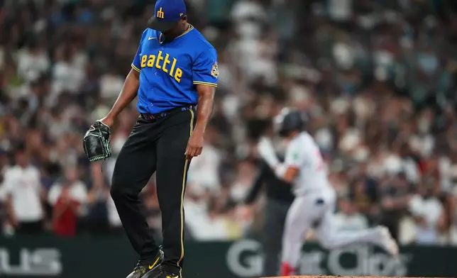 Seattle Mariners relief pitcher José A. Ferrer looks down as Minnesota Twins' Royce Lewis jogs the bases after hitting a solo home run during the seventh inning of a baseball game, Friday, July 31, 2026, in Seattle. (AP Photo/Lindsey Wasson)