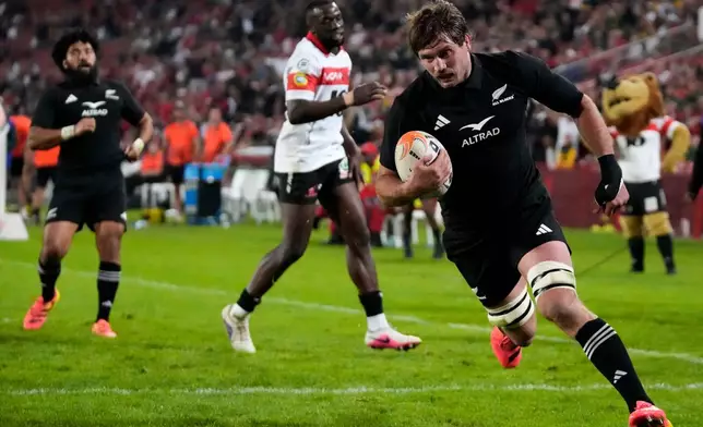 New Zealand's Ethan Blackadder scores a try during an international friendly rugby match between Lions and New Zealand, in Johannesburg, South Africa, Tuesday, Aug. 25, 2026. (AP Photo/Themba Hadebe)