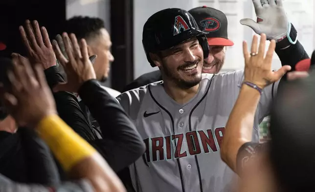 Arizona Diamondbacks' Nolan Arenado celebrates after hitting a solo home run off Cleveland Guardians relief pitcher Hunter Gaddis during the eighth inning of a baseball game, Saturday, Aug. 1, 2026, in Cleveland. (AP Photo/Phil Long)