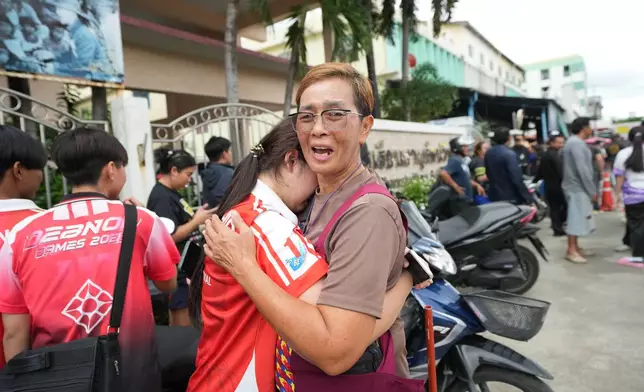 A schoolgirl cries outside her school where deaths and injuries were reported after a shooting in Thailand's Nonthaburi province, Friday, Aug. 7, 2026. (AP Photo/Sakchai Lalit)