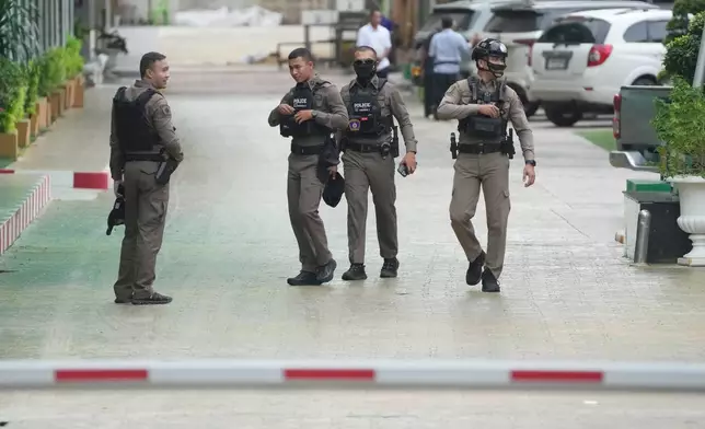 Police officers gather at Debsirin Nonthaburi School, a day after the shooting at the school in Nonthaburi province, Thailand , on Saturday, Aug. 8, 2026. (AP Photo/Sakchai Lalit)