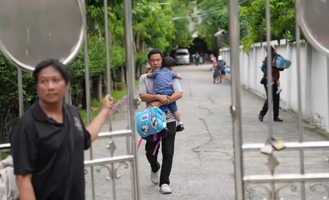 A parent leaves after picking his child after a shooting at the Debsirin Nonthaburi School in Thailand's Nonthaburi province, Friday, Aug. 7, 2026. (AP Photo/Sakchai Lalit)