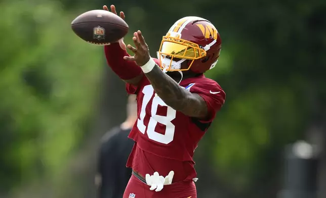 Washington Commanders wide receiver Stefon Diggs works out before a joint practice with the Miami Dolphins at NFL football training camp, Wednesday, Aug. 12, 2026 in Ashburn, Va. (AP Photo/Nick Wass)