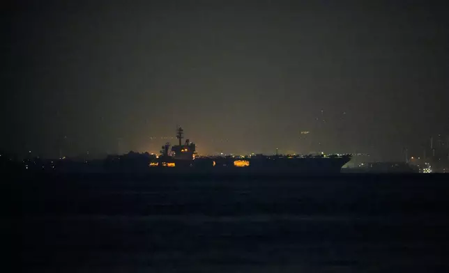 The U.S. Navy aircraft carrier USS Abraham Lincoln sails past Singapore as seen from Batam, Indonesia, Sunday, Aug. 30, 2026. (AP Photo/Dita Alangkara)