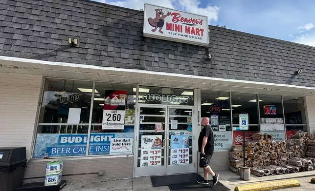A customer walks into Beaver's Mini Mart in Beavercreek, Ohio, Friday, Aug. 14, 2026. (AP Photo/Julie Carr Smyth)
