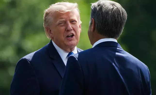 President Donald Trump, left, and CIA Director John Ratcliffe speak as they depart following a cabinet meeting at Camp David, near Thurmont, Md., Friday, July 31, 2026. (Nathan Howard/Pool Photo via AP)