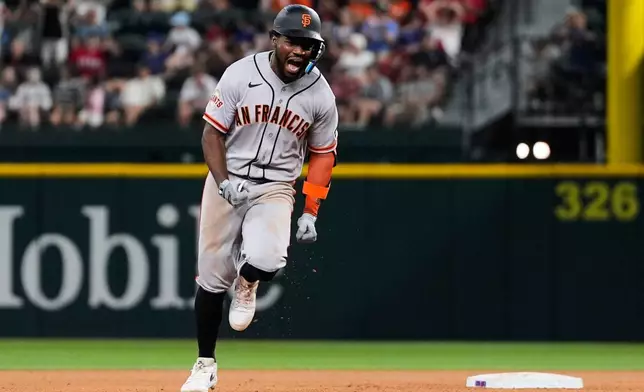 San Francisco Giants' Osleivis Basabe celebrates hitting a two-run home run in the seventh inning a baseball game against the Texas Rangers in Arlington, Texas, Tuesday, Aug. 4, 2026. (AP Photo/Tony Gutierrez)