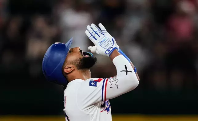 Texas Rangers' Ezequiel Duran celebrates his two-run double in the eighth inning a baseball game against the San Francisco Giants in Arlington, Texas, Tuesday, Aug. 4, 2026. (AP Photo/Tony Gutierrez)