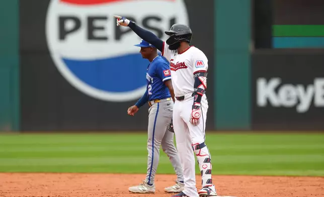 Cleveland Guardians' Jo Adell, right, gestures to the dugout after hitting a two-run double against the Kansas City Royals in the third inning of a baseball game in Cleveland, Sunday, Aug. 30, 2026. (AP Photo/Tim Phillis)