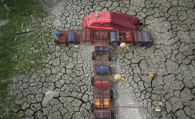A boat sits on dry ground as water levels have dropped on the Danube River in Petrovaradin, Serbia, Tuesday, Aug. 25, 2026. (AP Photo/Darko Vojinovic)