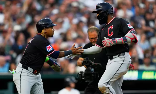 Cleveland Guardians' Jo Adell, right, celebrates his two-run home run with José Ramírez, left, against the Detroit Tigers during the fifth inning of a baseball game Wednesday, Aug. 12, 2026, in Detroit. (AP Photo/Paul Sancya)