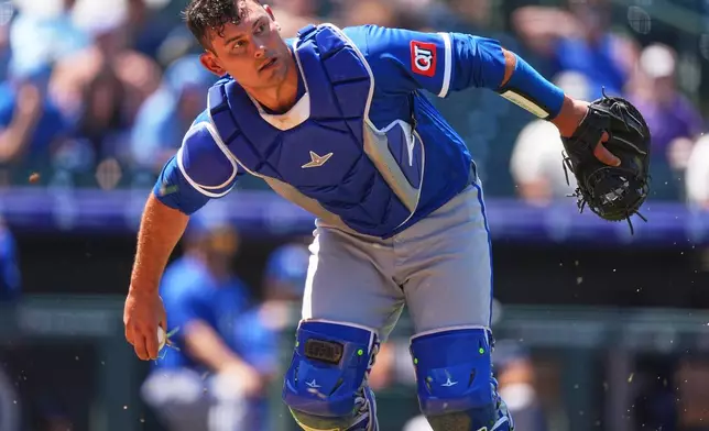 Kansas City Royals catcher Luke Maile throws to first base to put out Colorado Rockies' Willi Castro in the third inning of a baseball game Sunday, Aug. 2, 2026, in Denver. (AP Photo/David Zalubowski)