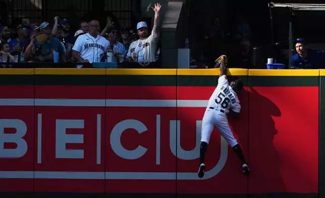 Seattle Mariners left fielder Randy Arozarena jumps to catch a long fly ball from Chicago Cubs' Miguel Amaya during the third inning of a baseball game, Saturday, Aug. 22, 2026, in Seattle. (AP Photo/Lindsey Wasson)
