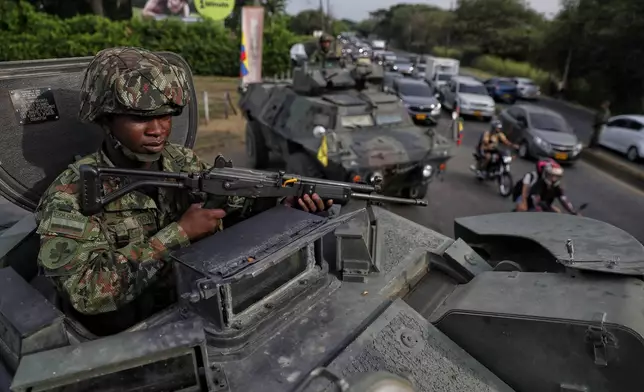 A soldier keeps watch from the turret of an armored vehicle ahead of the inauguration of President-elect Abelardo de la Espriella in Cali, Colombia, Wednesday, Aug. 5, 2026. (AP Photo/Santiago Saldarriaga)