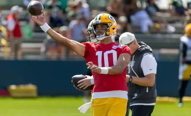 Green Bay Packers quarterback Jordan Love (10) participates in drills during the NFL football team's training camp, Sunday, Aug. 2, 2026, in Green Bay, Wis. (AP Photo/Mike Roemer)