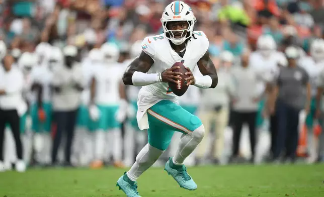 Miami Dolphins quarterback Malik Willis (2) aims a pass during the first half of an NFL preseason football game against the Washington Commanders, Friday, Aug. 14, 2026, in Landover, MD. (AP Photo/Nick Wass)