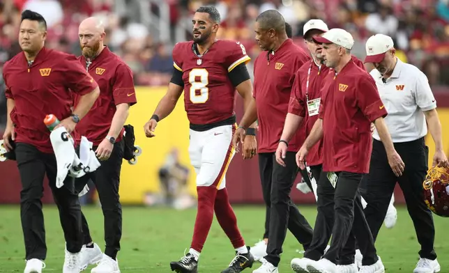 Washington Commanders quarterback Marcus Mariota (8) walks off the field during the first half of an NFL preseason football game against the Miami Dolphins, Friday, Aug. 14, 2026, in Landover, MD. (AP Photo/Nick Wass)