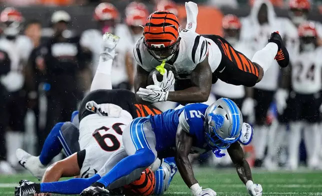 Detroit Lions cornerback Ennis Rakestraw Jr. (2) tackles Cincinnati Bengals running back Tahj Brooks (25) during the first half of a preseason NFL football game Thursday, Aug. 13, 2026, in Cincinnati. (AP Photo/Carolyn Kaster)