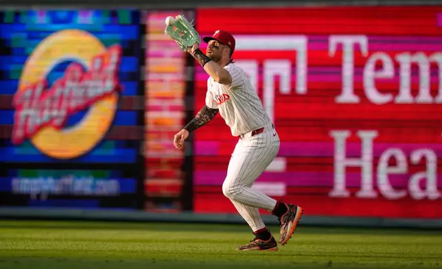 Philadelphia Phillies right fielder Bryce Harper catches a line out by Washington Nationals' Harry Ford during the second inning of a baseball game Tuesday, Aug. 4, 2026, in Philadelphia. (AP Photo/Matt Slocum)
